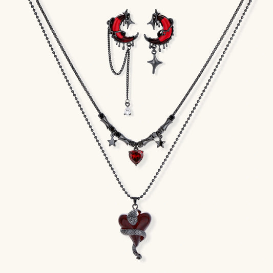 Gothic jewelry set with asymmetrical black metal earrings featuring red crescent moons, stars, and layered necklaces with heart pendants