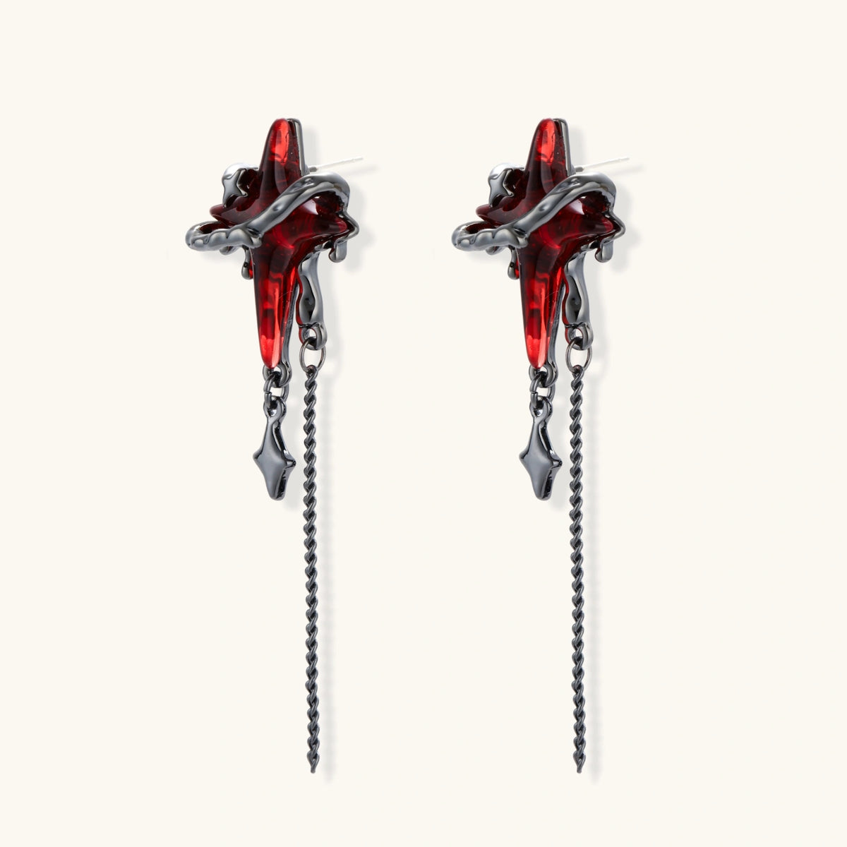 Gothic red resin dagger earrings with silver chain details and S925 posts on white background